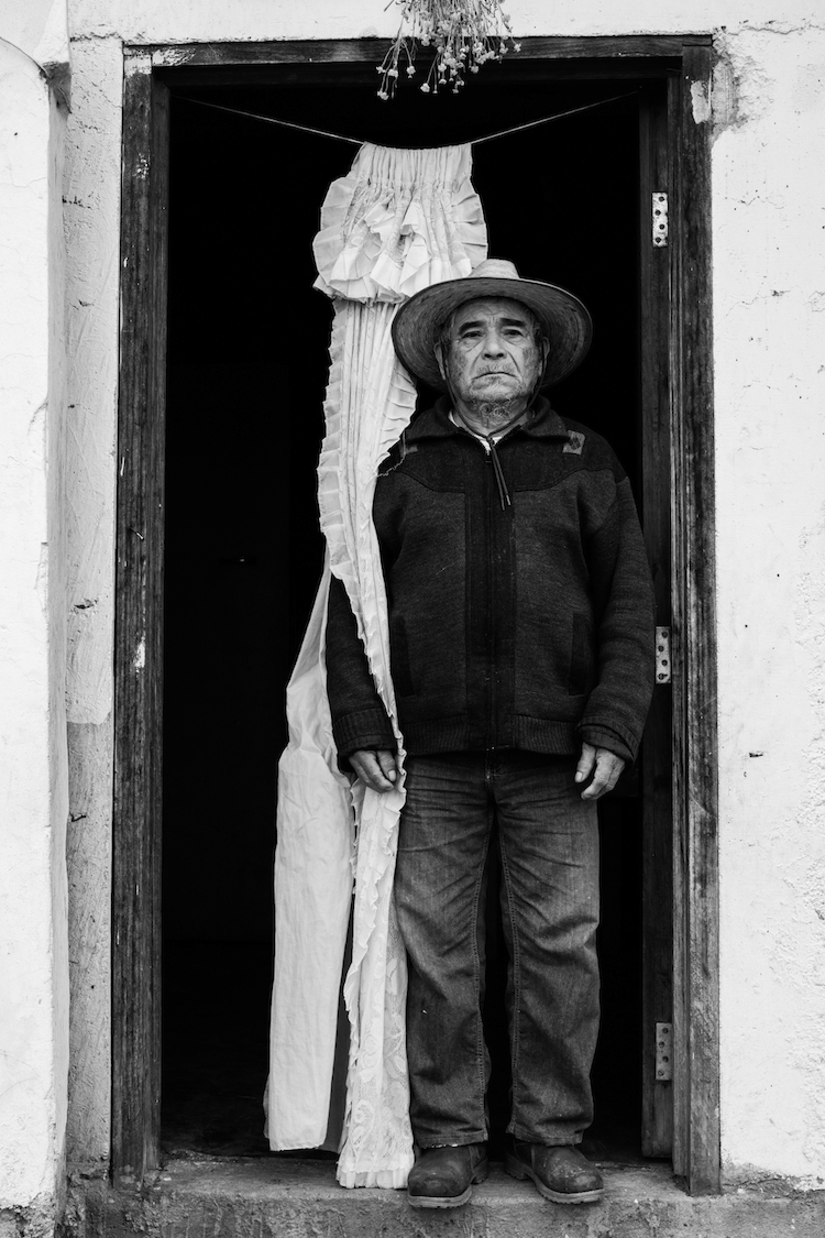 A Mixe man poses in his front door. Tamazulapam del Espiritu Santo, Oaxaca, Mexico.
