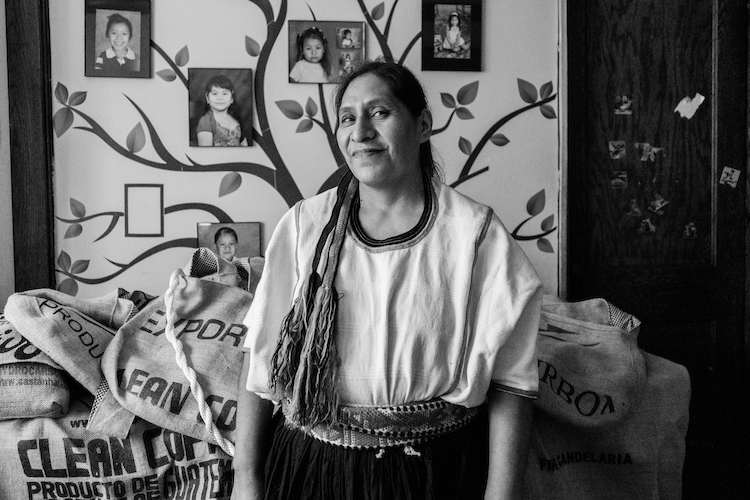 This Mixe woman works as an office cleaner, designs her own messenger bags from recycled coffee sacks on the side, while volunteering at her sons school daily. Milwaukee, Wisconsin, USA.