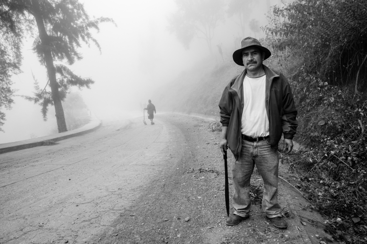 A Mixe man stops working to pose for a photo during "Tequio", the term for collective work. In this case, members of the community comb their neigborhoods, cleaning up trash and doing general landscaping. Tamazulapam del Espiritu Santo, Oaxaca, Mexico.